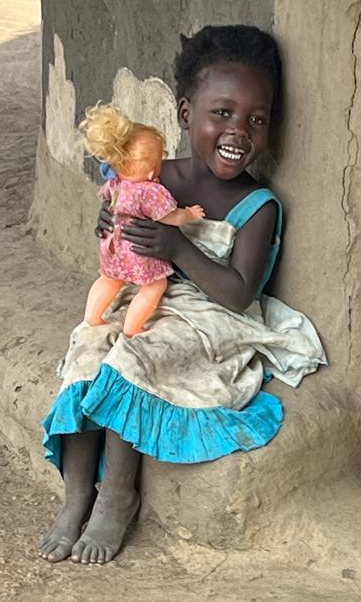 happy girl playing with doll